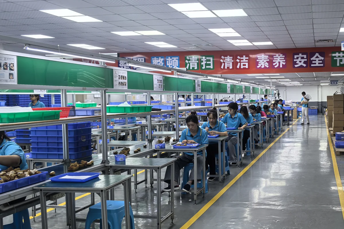 Toy assembly line workers at KingDa production facility
