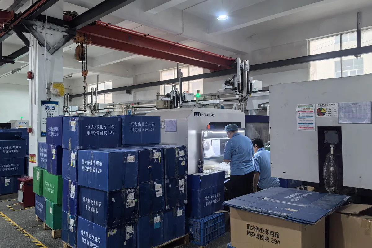 Injection molding machine with robotic arm at KingDa factory